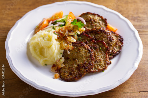 Beef liver pancakes with mashed potato and vegetables. Liver side dish