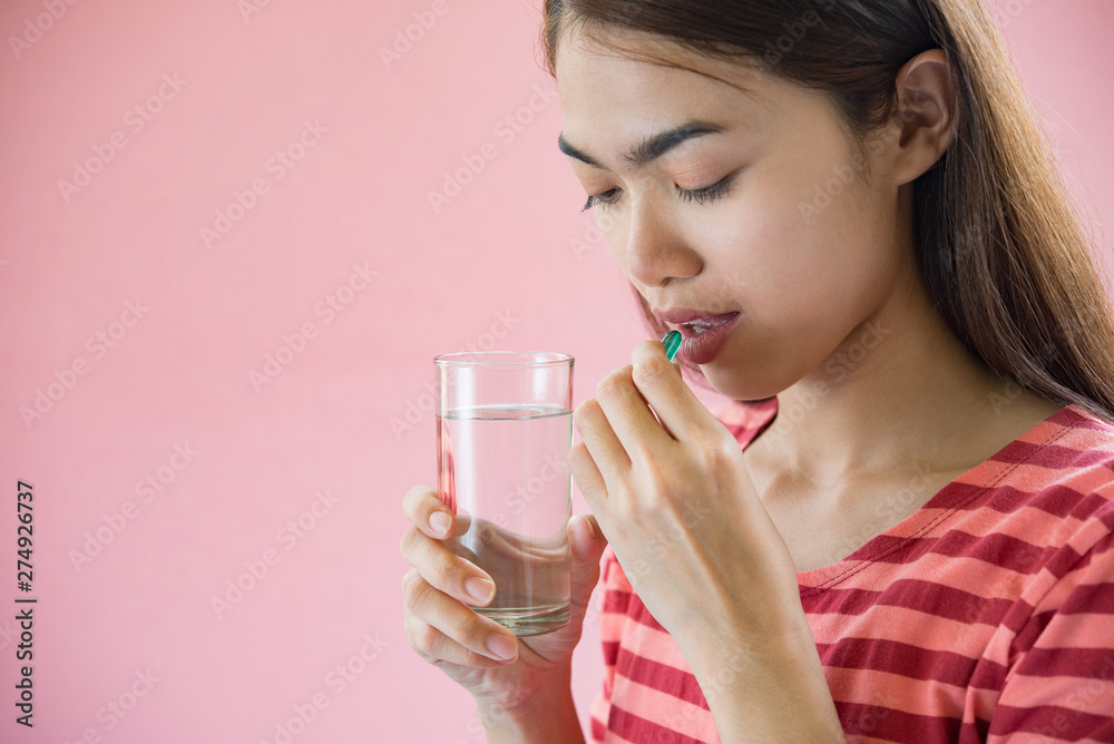 Young woman taking medicine pill after doctor order Young woman taking medicine pill after doctor order