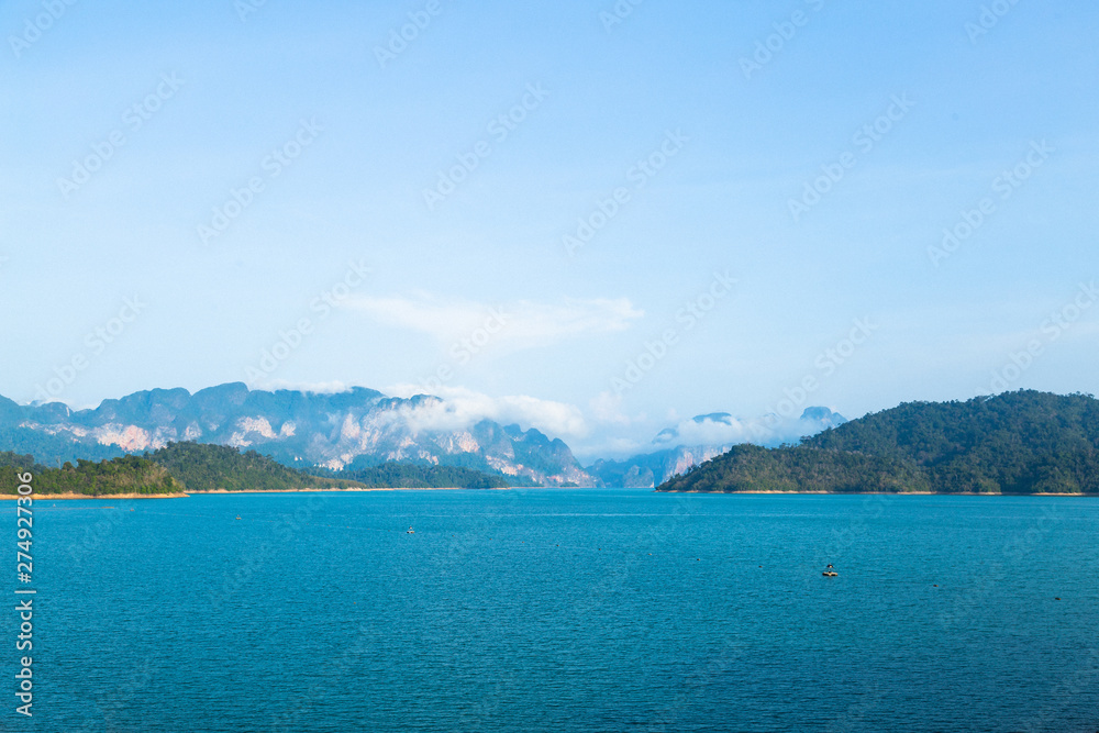 Clear Blue Sky over Blue Lake with Mountain Range in Thailand.