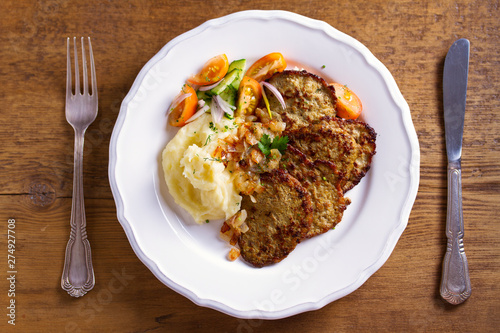 Beef liver pancakes with mashed potato and vegetables. Liver side dish. View from above, top studio shot