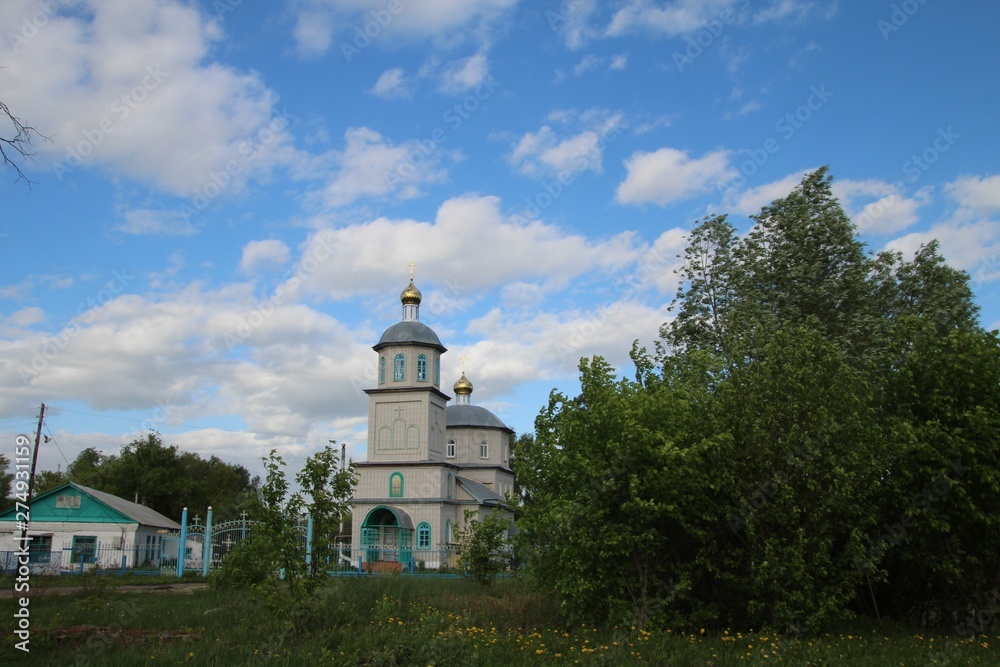 Spring landscape with a view of the Church of St. Nicholas the Wonderworker in the village of Ukhmany