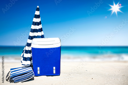Summer time on beach and free space for your decoration. Blue and white umbrella with landscape of ocean. 