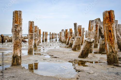 Beatiful old beach with wooden columnes photo