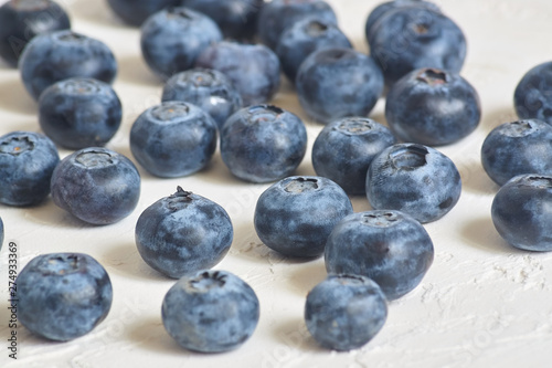 close up of  blueberries on white concrete background