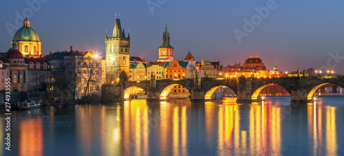 Sunset view on Prague old town and iconic Charles bridge on Vltava river, Czech Republic