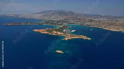 Fototapeta Naklejka Na Ścianę i Meble -  Aerial drone photo of famous luxurious Lemos peninsula in Vouliagemeni area with iconic celebrity sandy beach of Asteras, Athens riviera, Glyfada, Attica, Greece