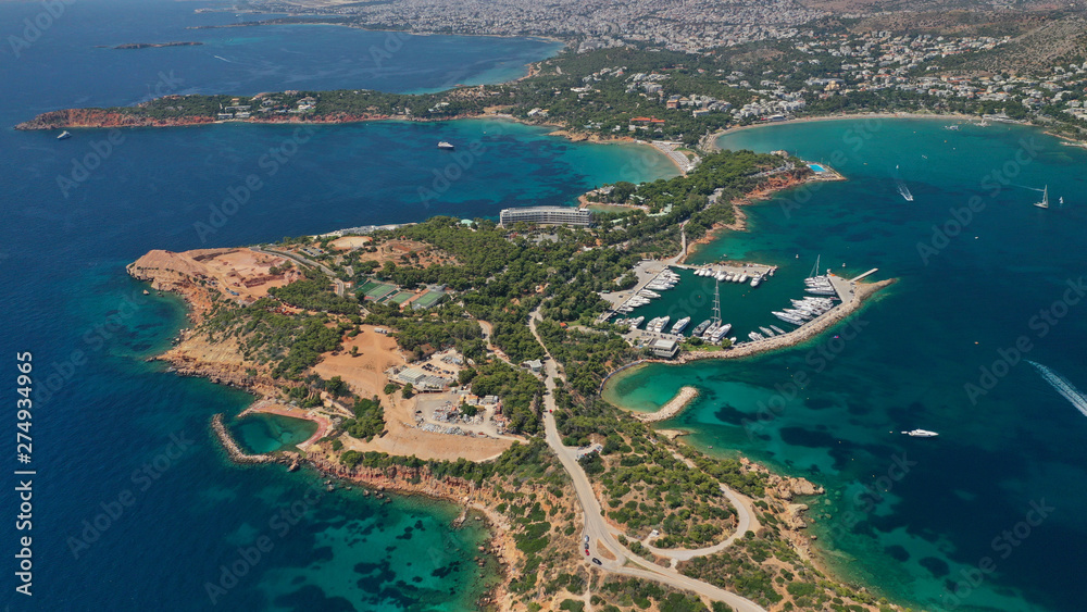 Aerial drone photo of famous luxurious Lemos peninsula in Vouliagemeni area with iconic celebrity sandy beach of Asteras, Athens riviera, Glyfada, Attica, Greece