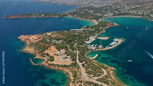 Aerial drone photo of famous luxurious Lemos peninsula in Vouliagemeni area with iconic celebrity sandy beach of Asteras, Athens riviera, Glyfada, Attica, Greece