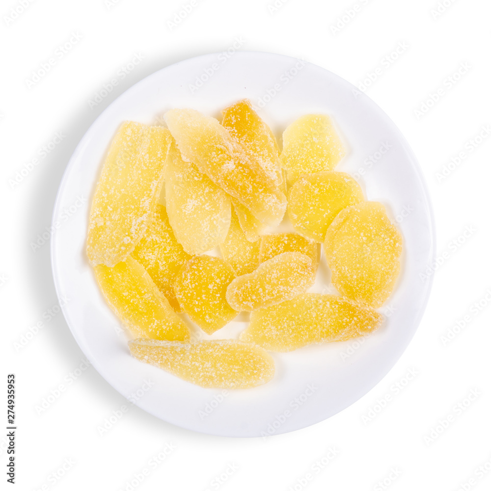 Ginger candied fruit, dried ginger with sugar in plate on a white background, top view on a white background, top view Ginger candied fruit, dried ginger with sugar in plate on a white background, top view on a white background, top view