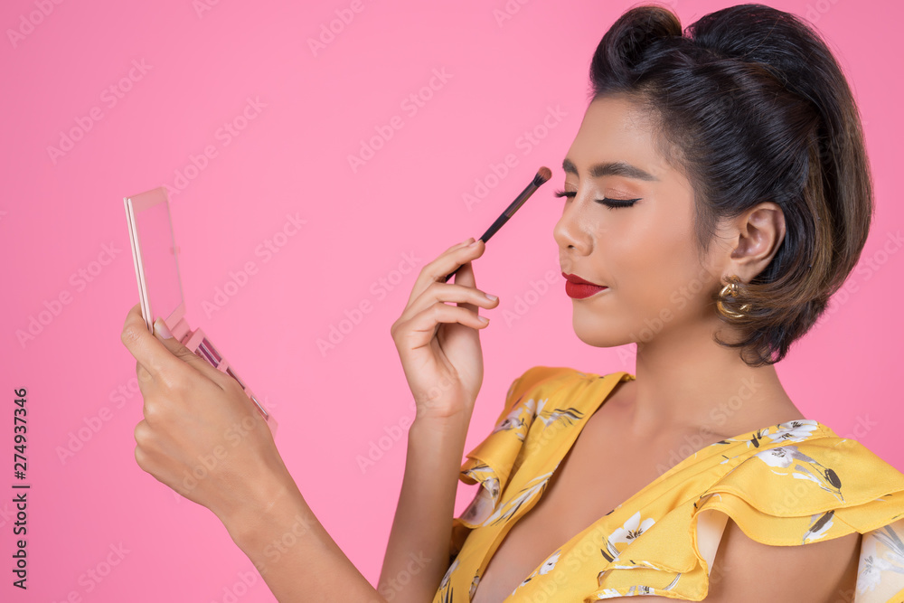 Portrait of woman with makeup brush and cosmetic Portrait of woman with makeup brush and cosmetic