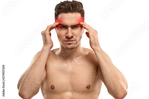 Man with headache rubbing temples