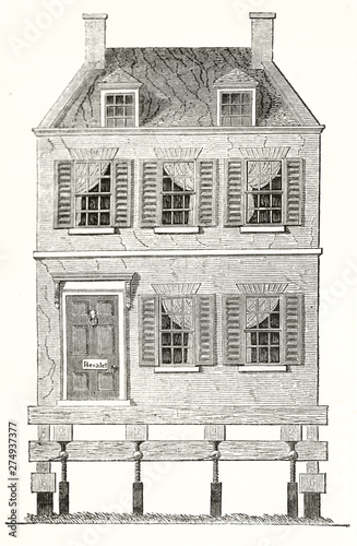 Front facade of a house builded on a wooden platform allowing the motion. Old illustration of mobile home in the United States. By unidentified author publ. on Magasin Pittoresque Paris 1848 photo