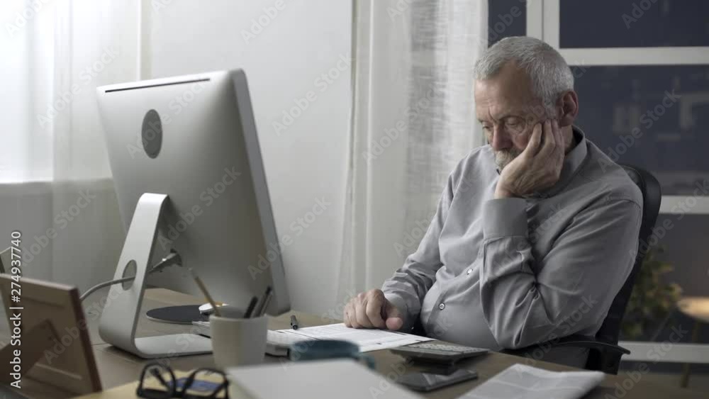 Senior man checking home finances and bills Senior man checking home finances and bills