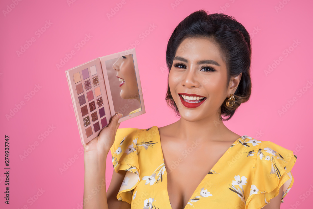 Portrait of woman with makeup brush and cosmetic Portrait of woman with makeup brush and cosmetic