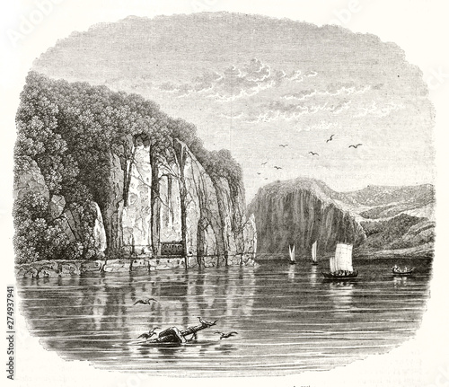 Flat water on Danube river reflecting the overhanging cliff and the Tabula Traiana. Wonderful etching style landscape by Wiesener publ. on Magasin Pittoresque Paris 1848 photo