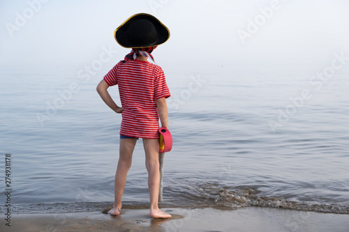 Pirate child looks towards the sea