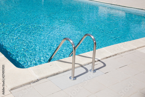 Steps on outdoor blue swimming pool