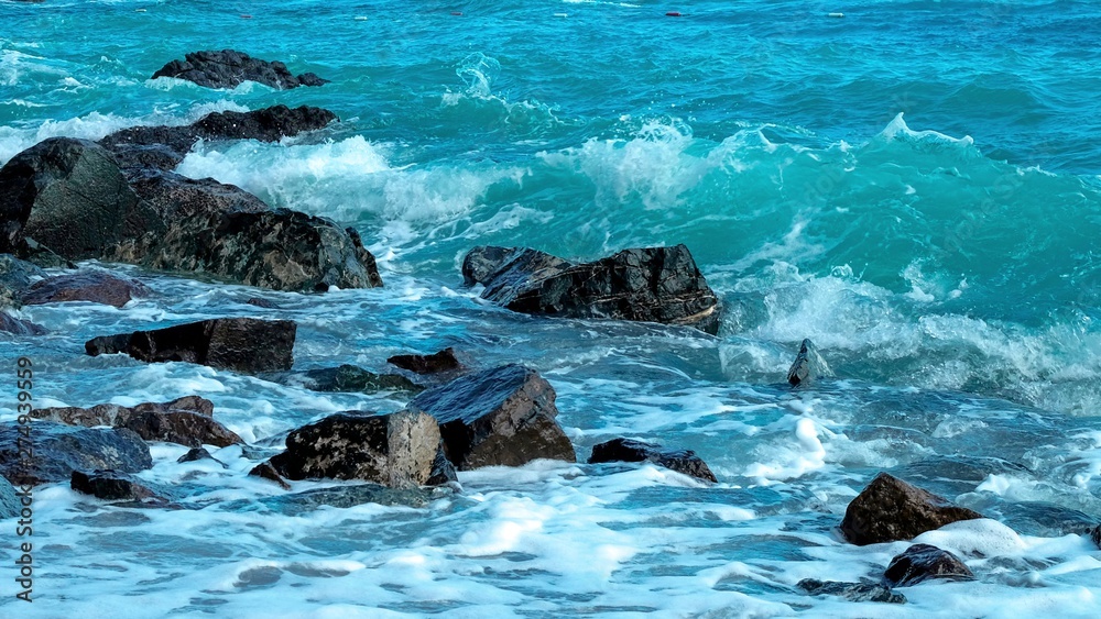 Breaking wave with interesting splash and rocks in the foreground Breaking wave with interesting splash and rocks in the foreground