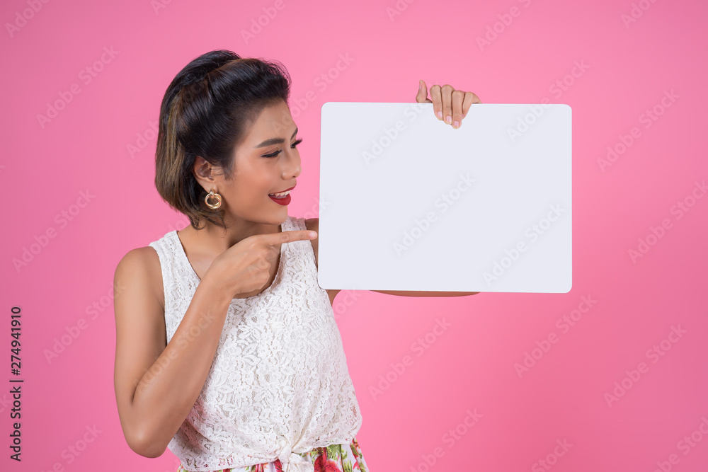Portrait of fashion woman displaying white banner Portrait of fashion woman displaying white banner