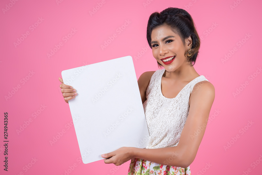 Portrait of fashion woman displaying white banner Portrait of fashion woman displaying white banner