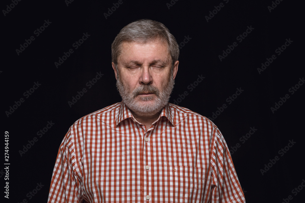 Close up portrait of senior man isolated on black studio background. Photoshot of real emotions of male model with closed eyes. Thoughtful. Facial expression, human nature and emotions concept. Close up portrait of senior man isolated on black studio background. Photoshot of real emotions of male model with closed eyes. Thoughtful. Facial expression, human nature and emotions concept.