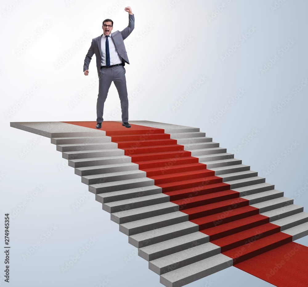 Young businessman climbing stairs and red carpet Young businessman climbing stairs and red carpet