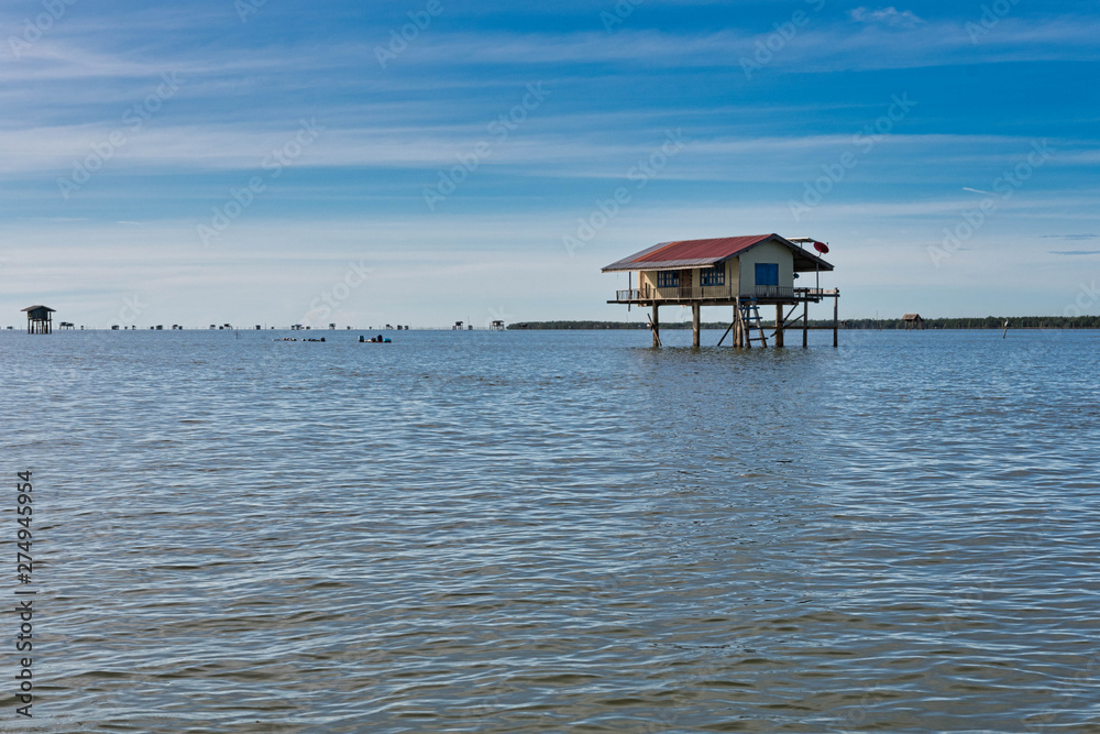 Traditional Thai fisherman houses made of wood in the middle of the sea