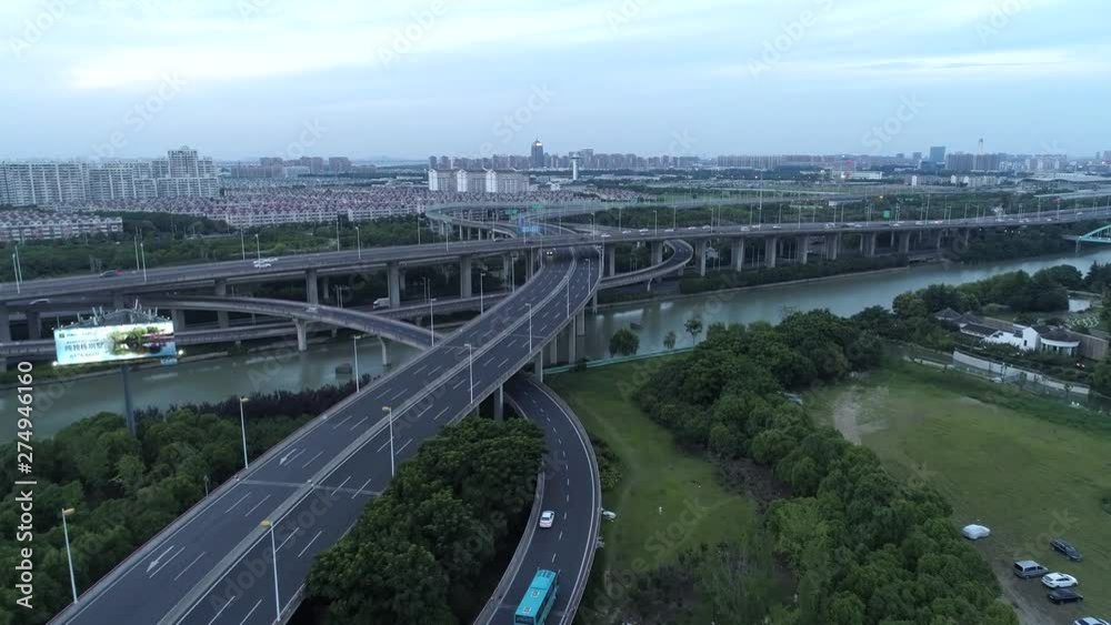 Aerial drone view of highway multi-level junction road with moving cars at sunset. Cars are moving on a multi-level road junction The concept of the urban. Suzhou city, China. Aerial drone view of highway multi-level junction road with moving cars at sunset. Cars are moving on a multi-level road junction The concept of the urban. Suzhou city, China.