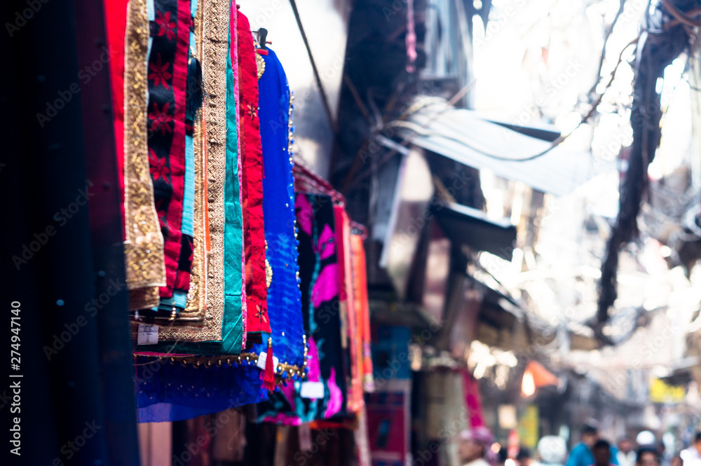 Beautiful handicraft scarves and shawls hanging on a street side shop for sale