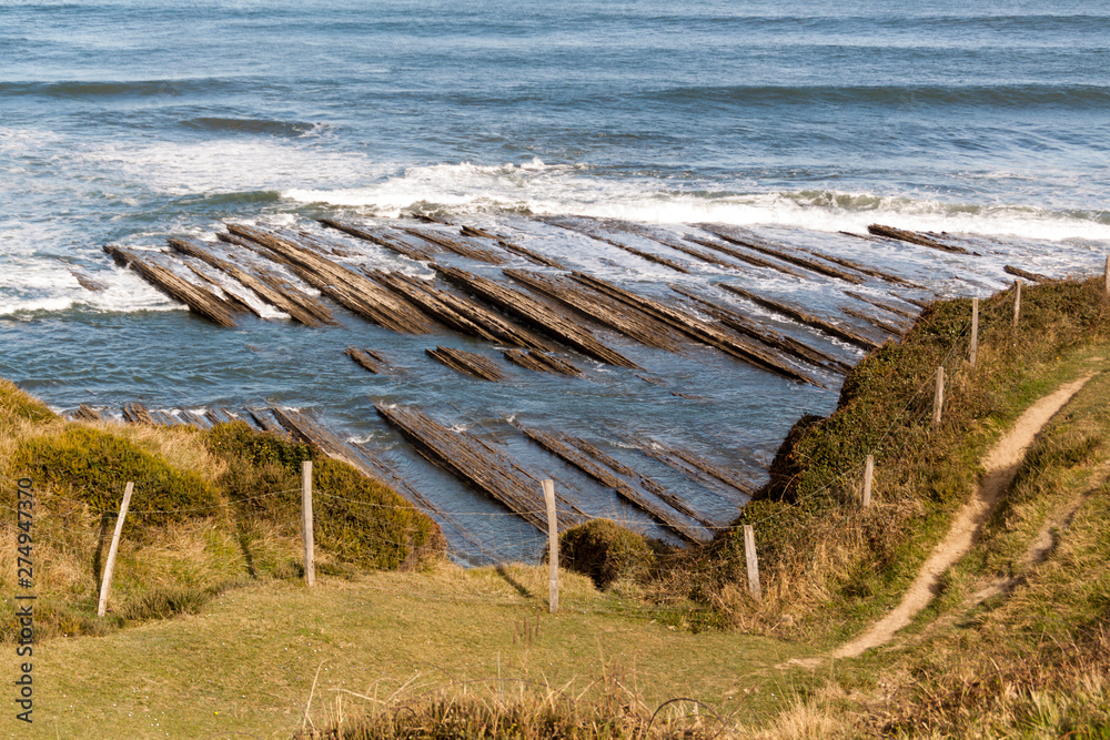 Geological rock formations and cliffs on the Flysch route. Cantabrian Sea. In Vizcaya, Basque Country. Spain