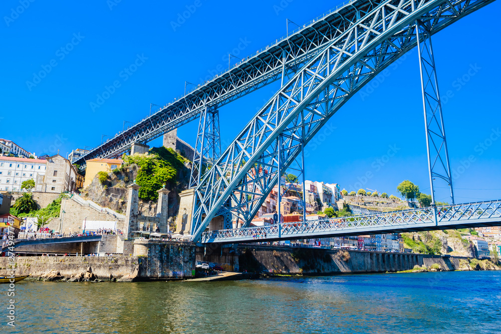 Famous steel bridge dom Luis above connects Old town Porto with Vila Nova de Gaia at river Douro, Portugal. Famous steel bridge dom Luis above connects Old town Porto with Vila Nova de Gaia at river Douro, Portugal.
