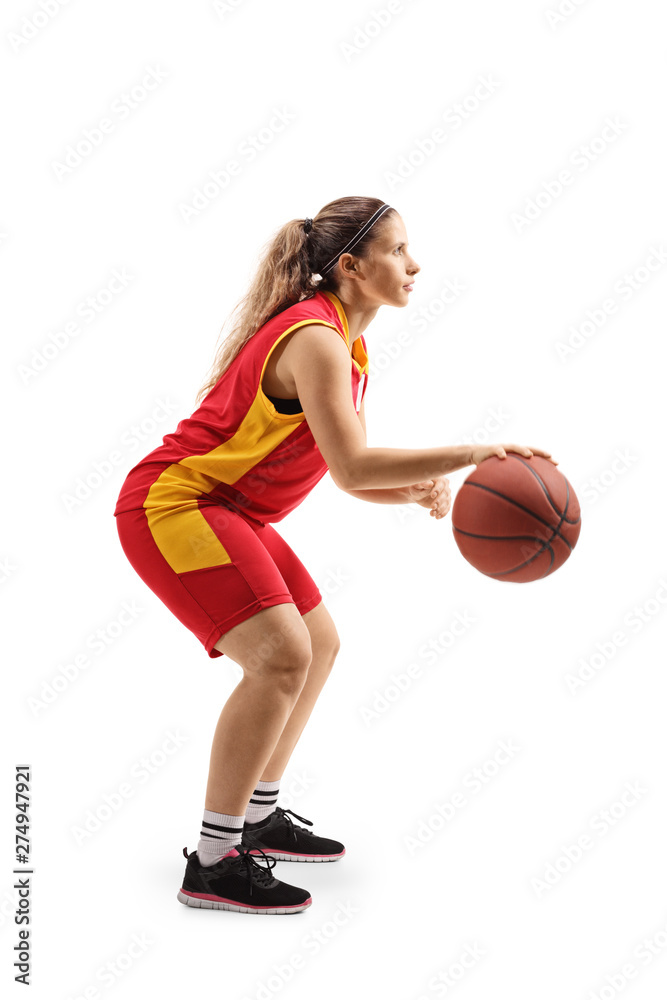 Young woman in a sports jersey playing basketball