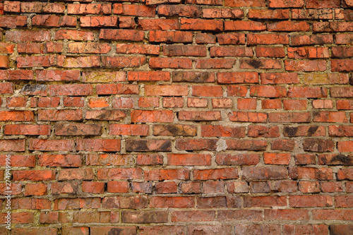 Old brick wall weathered and broken bricks  background