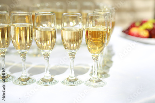 transparent champagne glasses on a white table