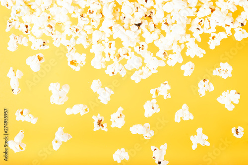 Scattered popcorn over yellow background