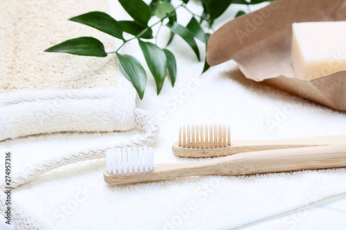 Bamboo toothbrushes with towel  soap and green leafs