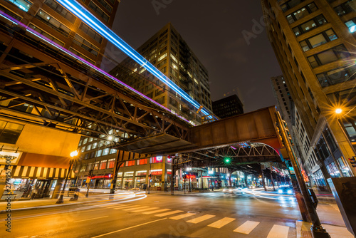 An L train runs over West Monroe Street and South Wabash Avenue. photo