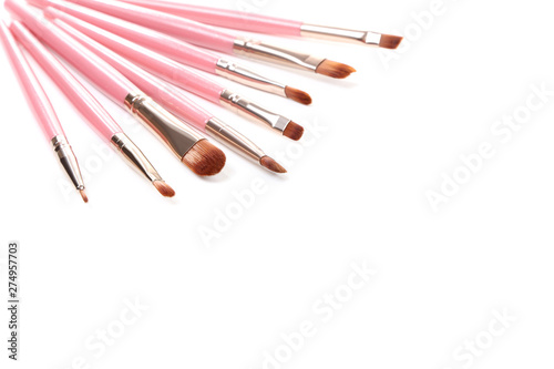 Pink makeup brushes isolated on white background