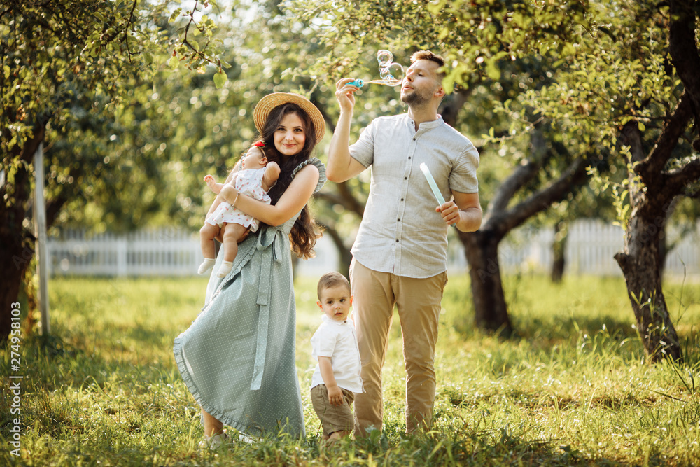 Happy family in the green garden at summer