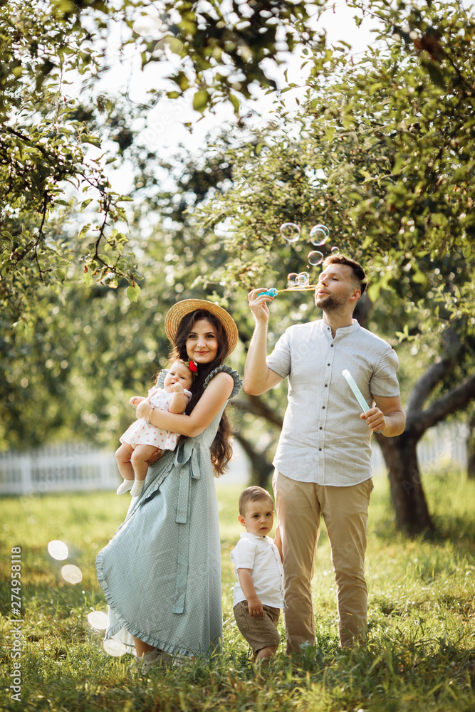 Happy family in the green garden at summer