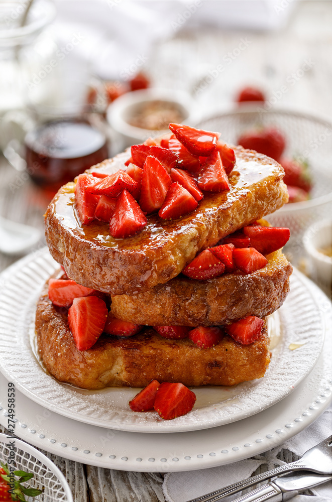 French toasts, French toasts made of sliced brioche with fresh strawberries and honey. Delicious breakfast or dessert French toasts, French toasts made of sliced brioche with fresh strawberries and honey. Delicious breakfast or dessert