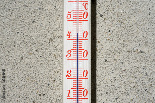 Thermometer on wall during hot weather