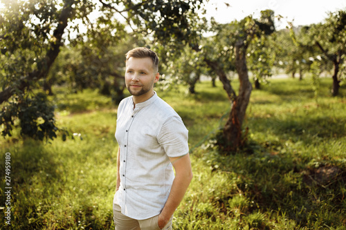 Handsome men in the green garden © shunevich