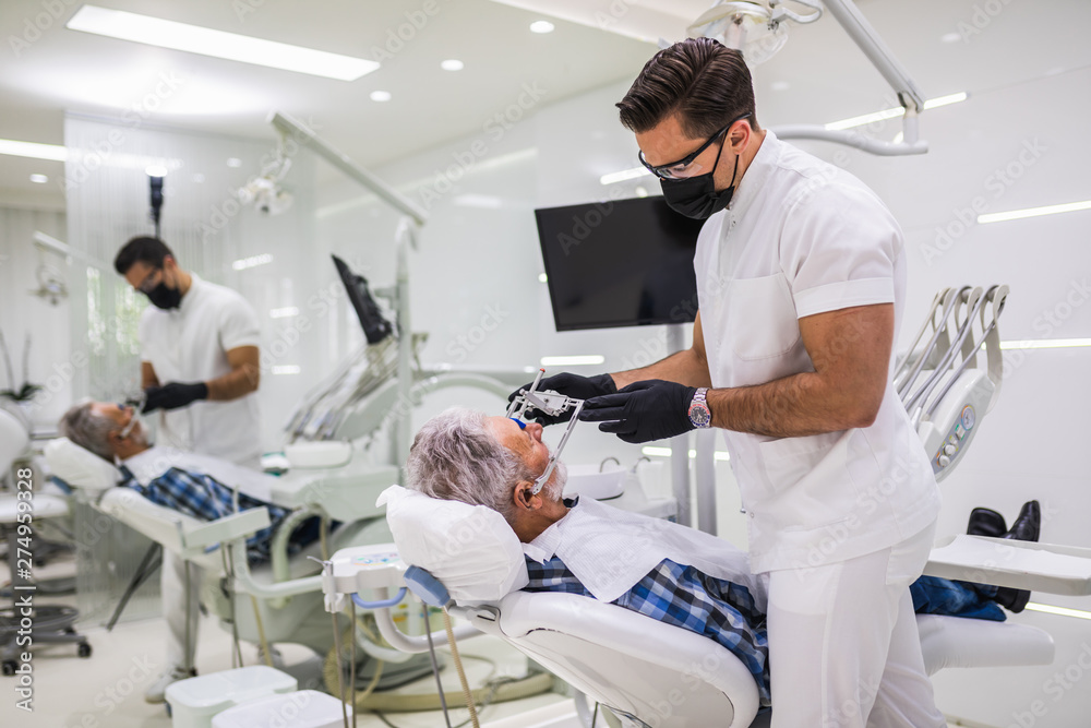 Senior man having dental treatment at dentist's office. Senior man having dental treatment at dentist's office.