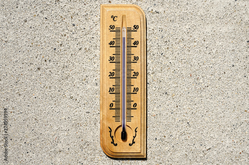 Thermometer on wall during hot weather