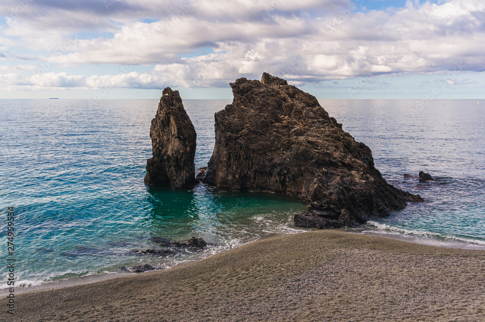 Φωτογραφία The Rock of Monterosso al Mare in the morning tide washing the beach of the lovely village