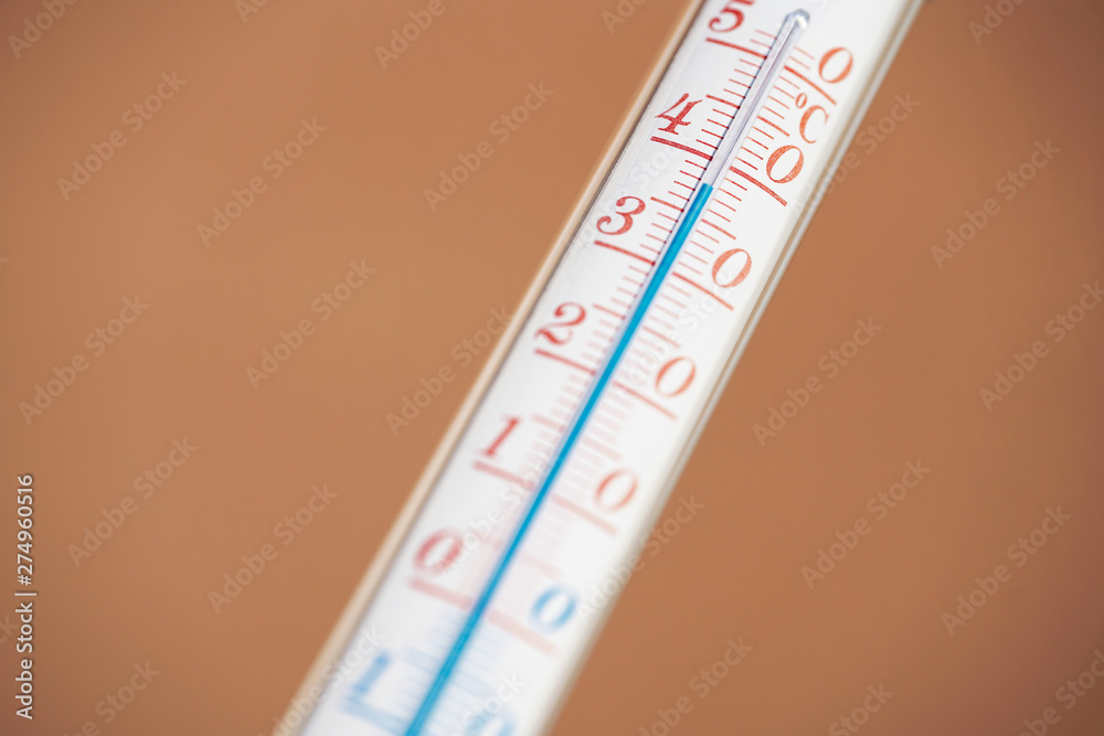 Thermometer during hot weather with solid background Thermometer during hot weather with solid background