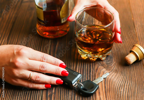 Subject binge alcohol behind the wheel. Not sober driver with a glass of whiskey.