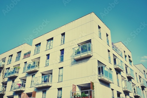 Modern apartment building exterior. Retro colors stylization © Grand Warszawski