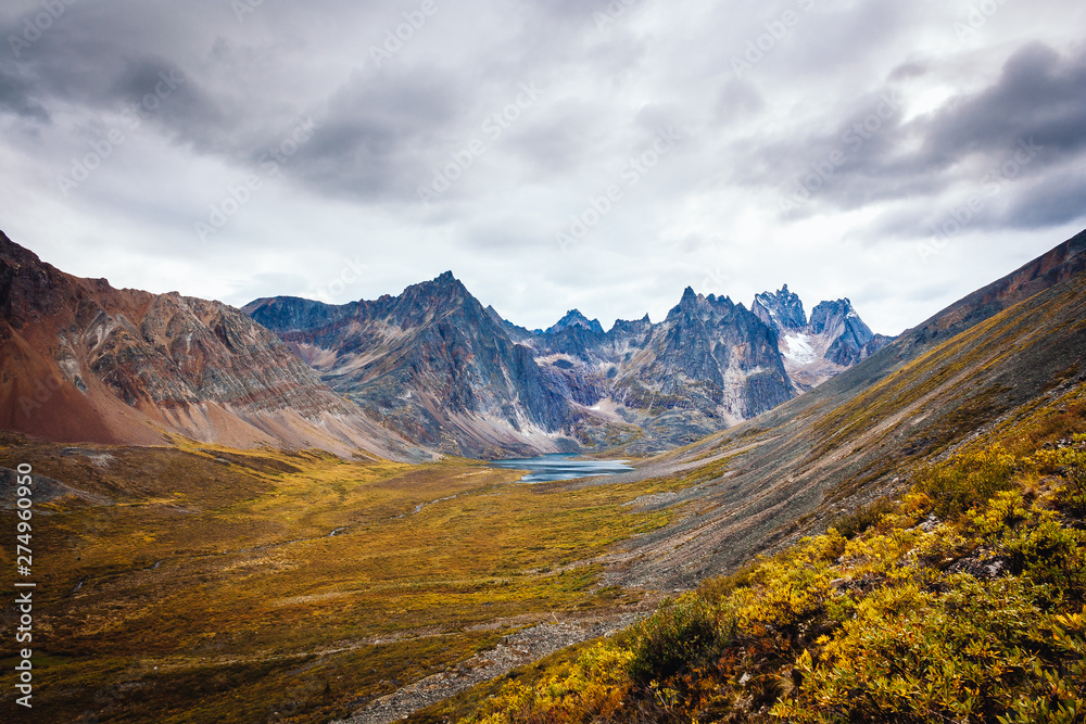 View of the mount Monolith and grizzly lake from the hiking trail of the Tombstone Park in Yukon, Canada. Wide angle shot of the late summer colors.